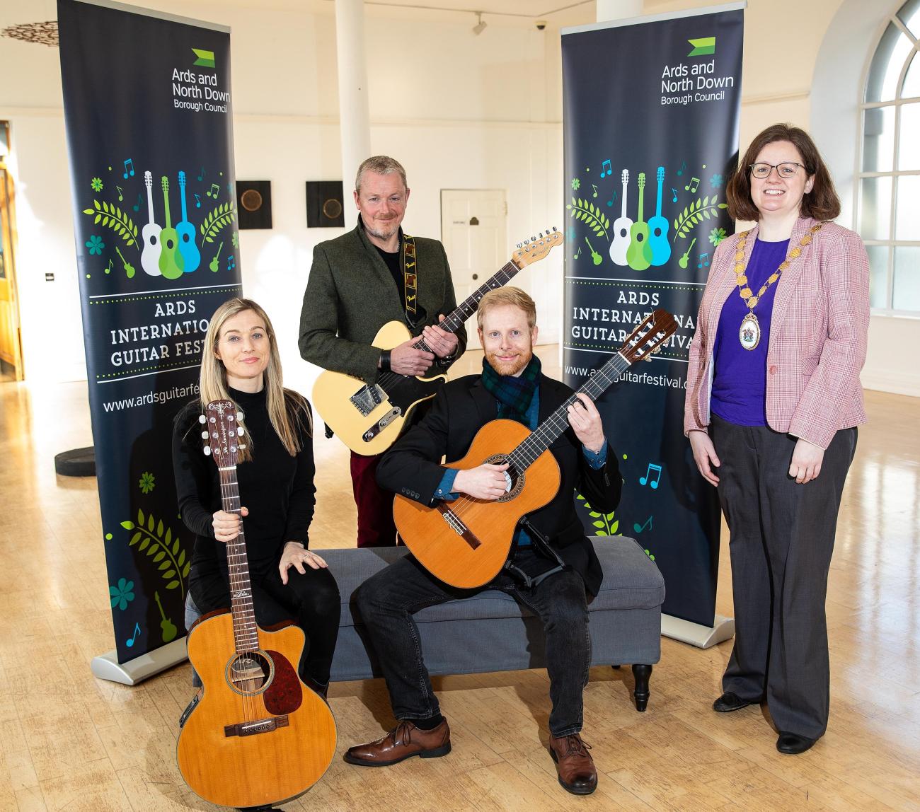 Three of the guitarists performing at the Ards Guitar Festival 2024 pose with their guitars with the current mayor of Ards, Jennifer Gilmour.
